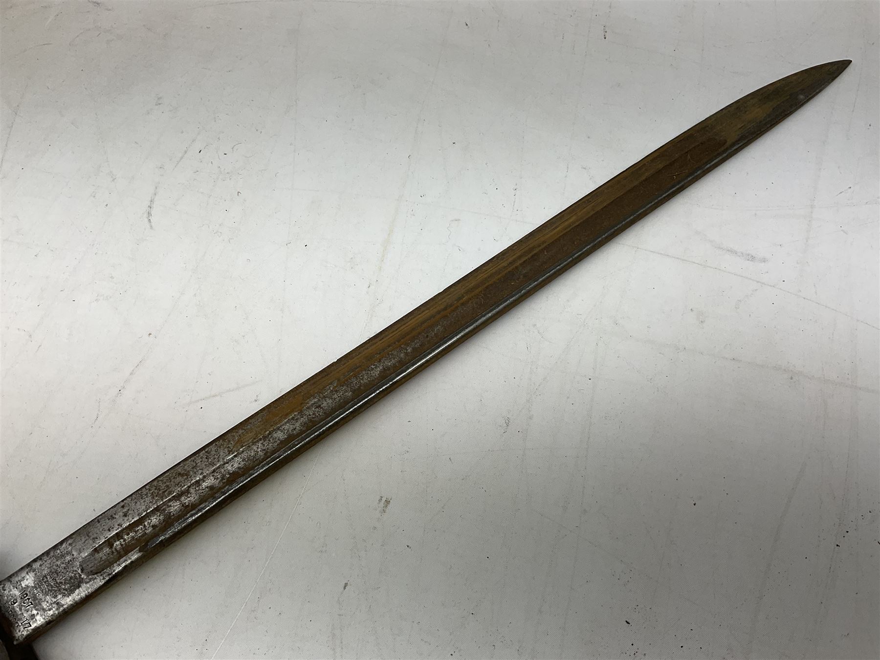 British Pattern 1907 bayonet with 43.5cm fullered steel blade; in leather scabbard with webbing frog L58cm overall; another Pattern 1907 bayonet lacking scabbard; and British Pattern 1888 Mk.I bayonet by Wilkinson London (no scabbard) (3)