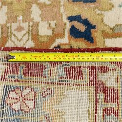 Agra wool runner, cream field decorated with large stylised palmettes, scrolling vines and flowerheads, enclosed by red main border with foliate motifs and fringed ends