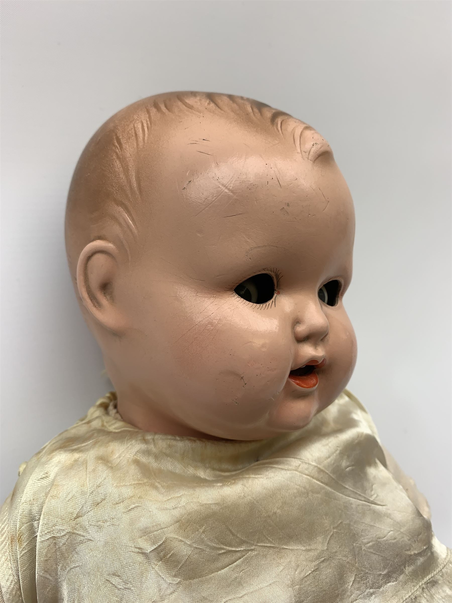 Seyfarth & Reinhardt composition head baby doll with moulded hair, sleeping flirty eyes, open mouth with one tooth and tongue and soft body with composition jointed limbs, marked 'SuR Germany 30/5' H47cm; together with a Golborne Dolls 'Golborne Beauty' composition head and body bride doll, marked 'F.P.23' in original box H63cm (2)