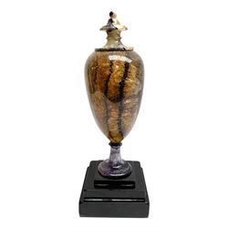 Early 19th century and later Blue John urn, Winnats one vein, of ovoid form with integrated cover and ball finial, upon a spreading circular base, and square stepped black lacquered base, H34.5cm
