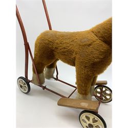 Pedigree push along plush covered horse 1950s-60s with red tubular metal framework and beech foot rests H25