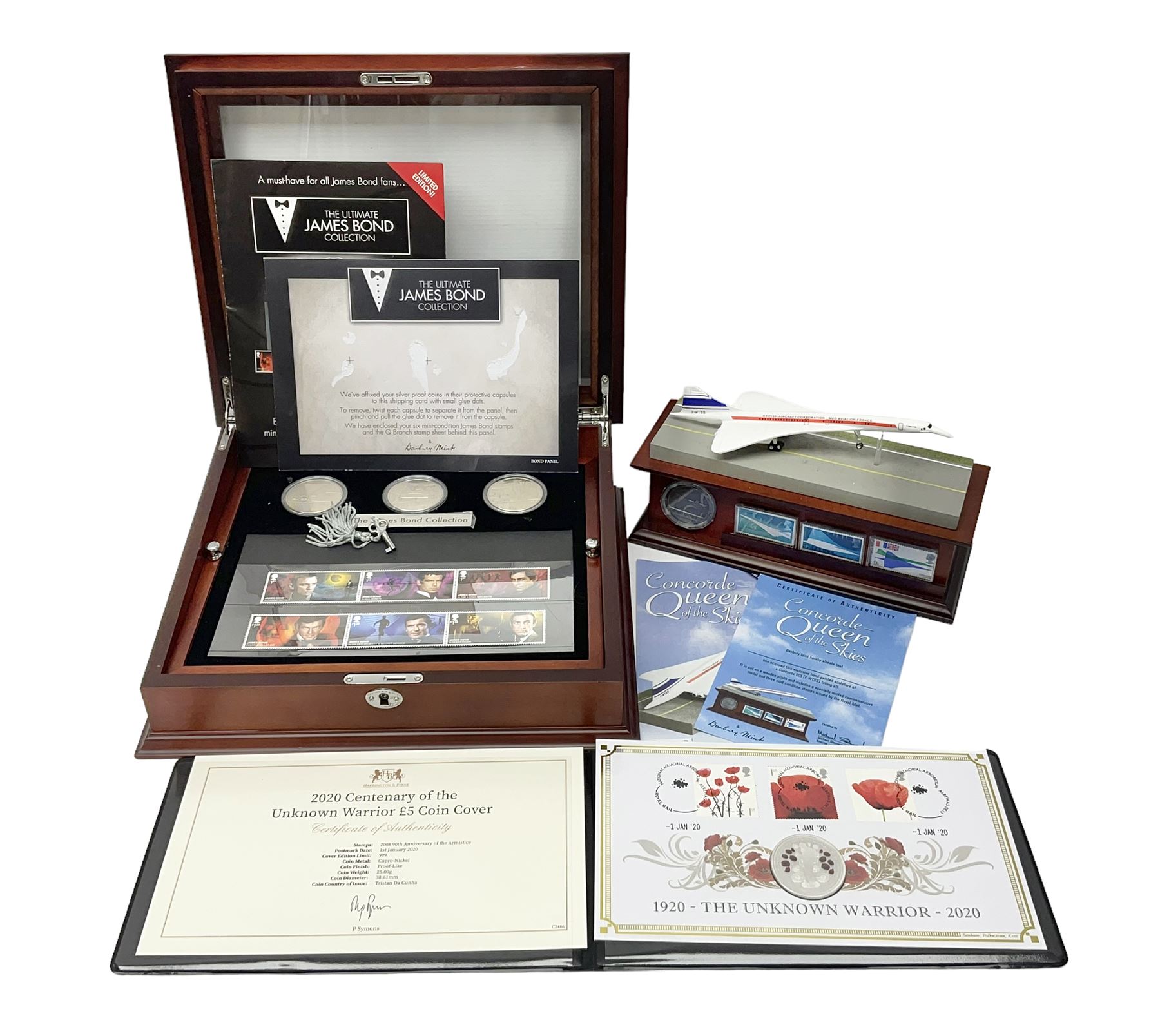Danbury Mint 'The Ultimate James Bond Collection' comprising stamps and coins housed in a display case, 'Concorde Queen of the Skies' sculpture, stamps, medallion display and 2020 'Centenary of the Unknown Warrior' five pound coin cover in Harrington and Byrne folder