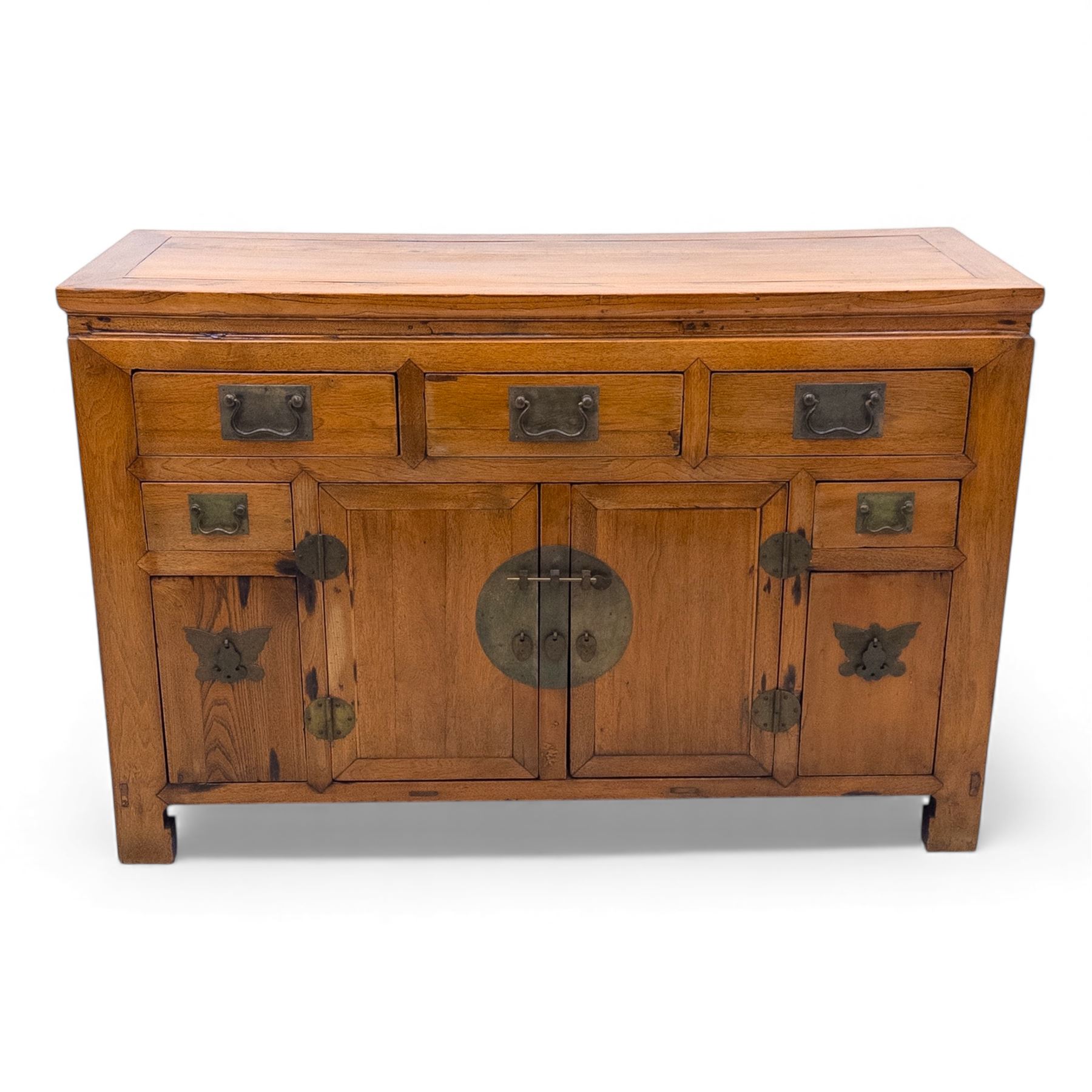 Late 20th-century Thai elm sideboard fitted with an arrangement of three drawers over a central cupboard flanked by a further two drawers, raised on square post feet 