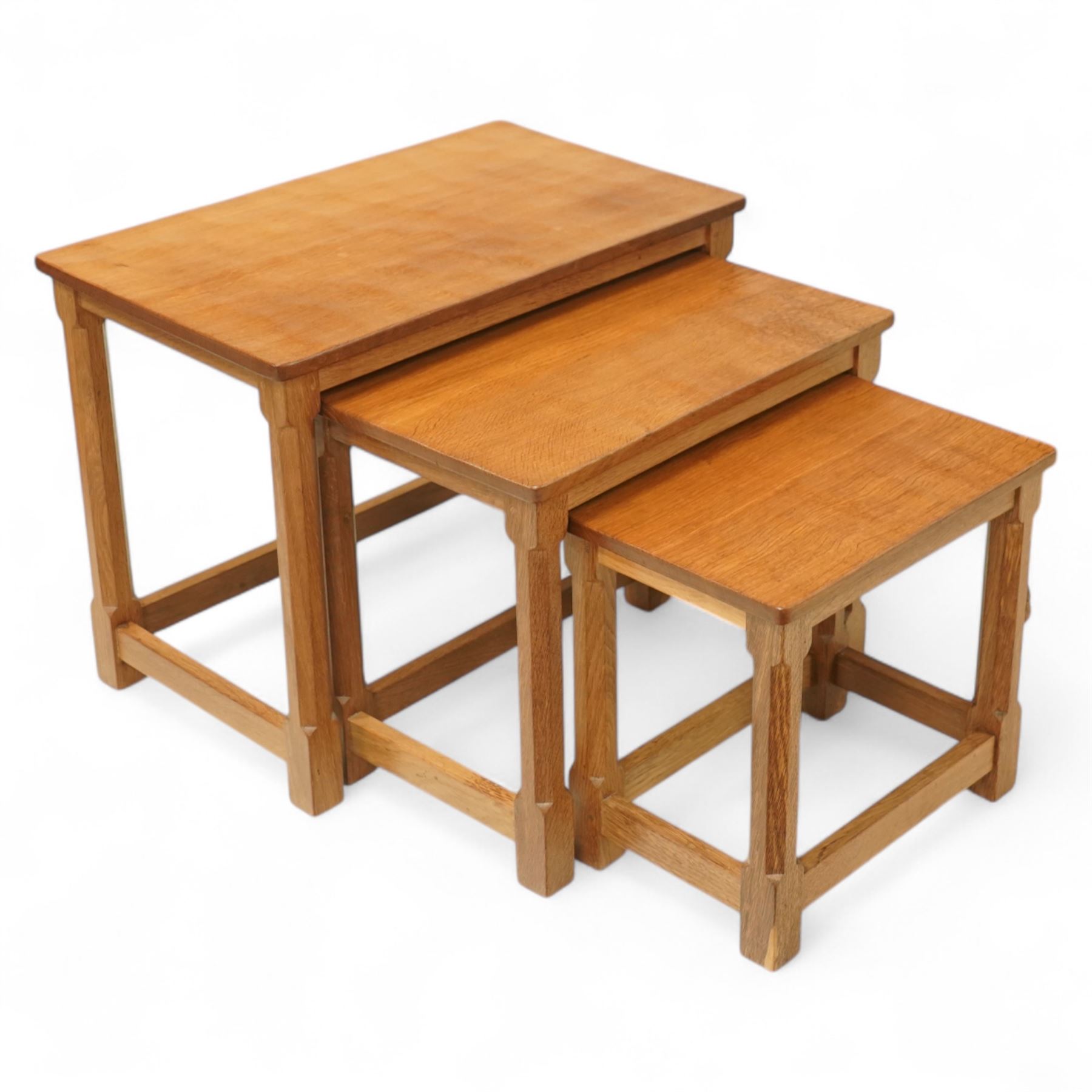 Mouseman - nest of three oak occasional tables, rectangular adzed top, on octagonal supports united by plain stretchers, each carved with mouse signature, by the workshop of Robert Thompson, Kilburn 