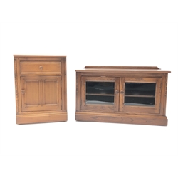  Ercol Golden Dawn finish elm lowline two door cabinet, plinth base (W96cm, H60cm, D48cm)  and matching cupboard with single drawer (W52cm, H71cm, D50cm) (2)  