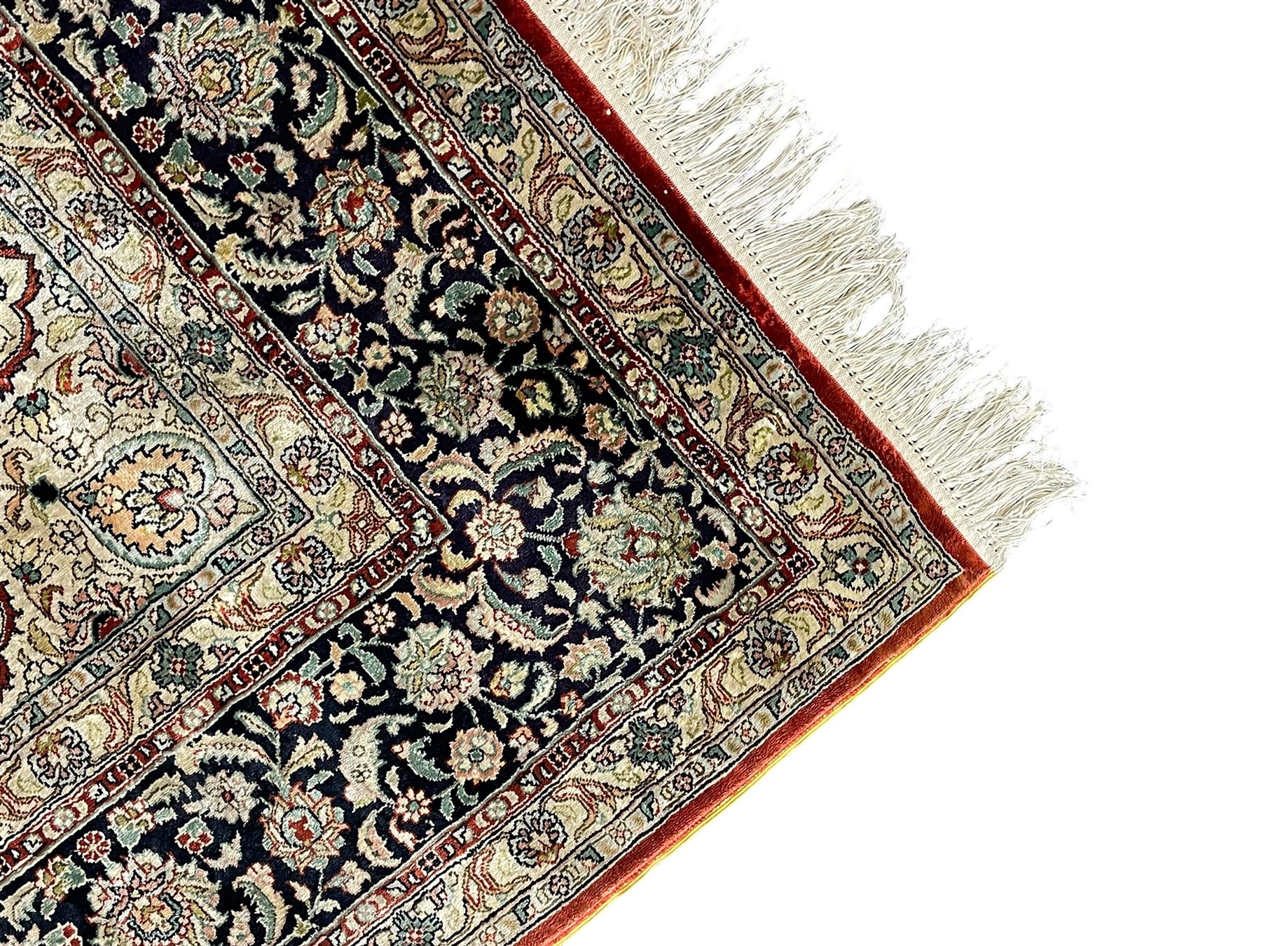 Persian silk finely knotted rug, central floral rosette medallion surrounded by curling branches decorated with palmettes, repeating pattern borders decorated with stylised plants and trailing leafy branches  