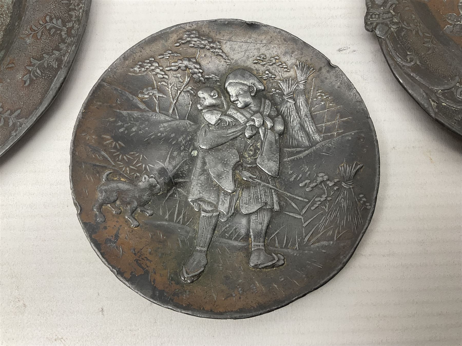 Brass sunfish ashtray, Chinese silver plated trinket box with mirror, bronzed matchbox cover and a collection of other Oriental bronzed embossed metal trays