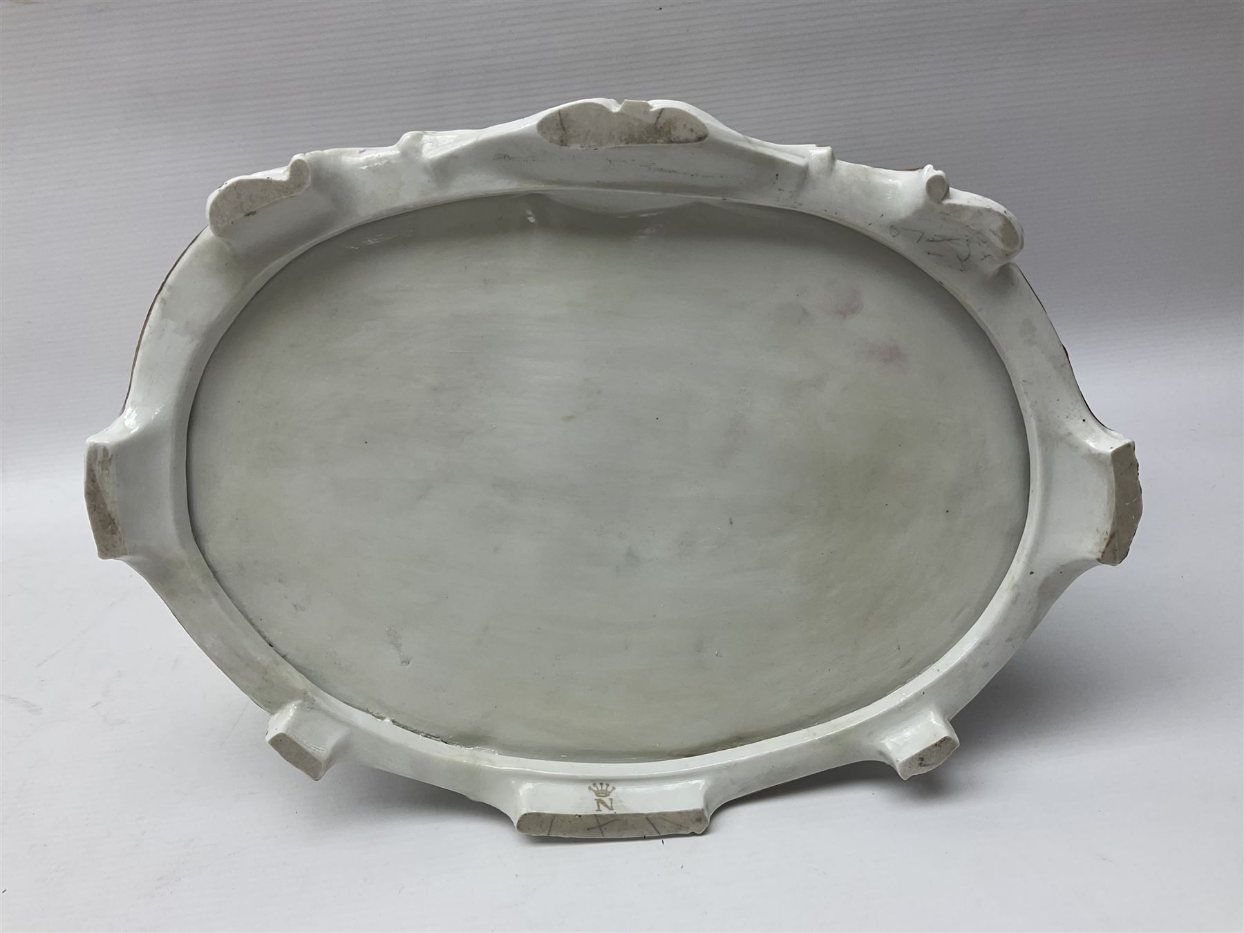 20th century Naples figure group, modelled as a seated female figure playing the lute seated, before a male figure stood holding a sheet of music, each in period dress, upon an oval base with gilt heightened scroll edge, with crowned N mark beneath, H31.5cm L33cm
