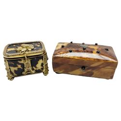 George III tortoiseshell trinket box with initialled panel and studwork decoration to the hinged cover, upon four turned ivory feet, H3cm L6.5cm D3.5cm, together with a Victorian gilt mounted tortoiseshell trinket box, with stylised mounts and musical trophy decoration to the hinged cover, upon four ball feet, H3cm L4cm D3cm, (2)