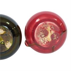Christopher Dresser for Linthorpe Pottery, two of miniature jugs in red and green, shape number 850, with impressed mark beneath, H9cm