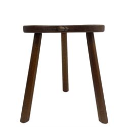 'Mouseman' oak three-legged stool, kidney shaped dished seat carved with mouse signature to edge, by Robert Thomas of Kilburn