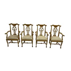 Set eight light oak Chippendale style carver dining chairs, shaped cresting rail with pierced and scrolled splat backs, upholstered seats with scrolling arm terminal, chamfered supports united by stretchers with pad feet