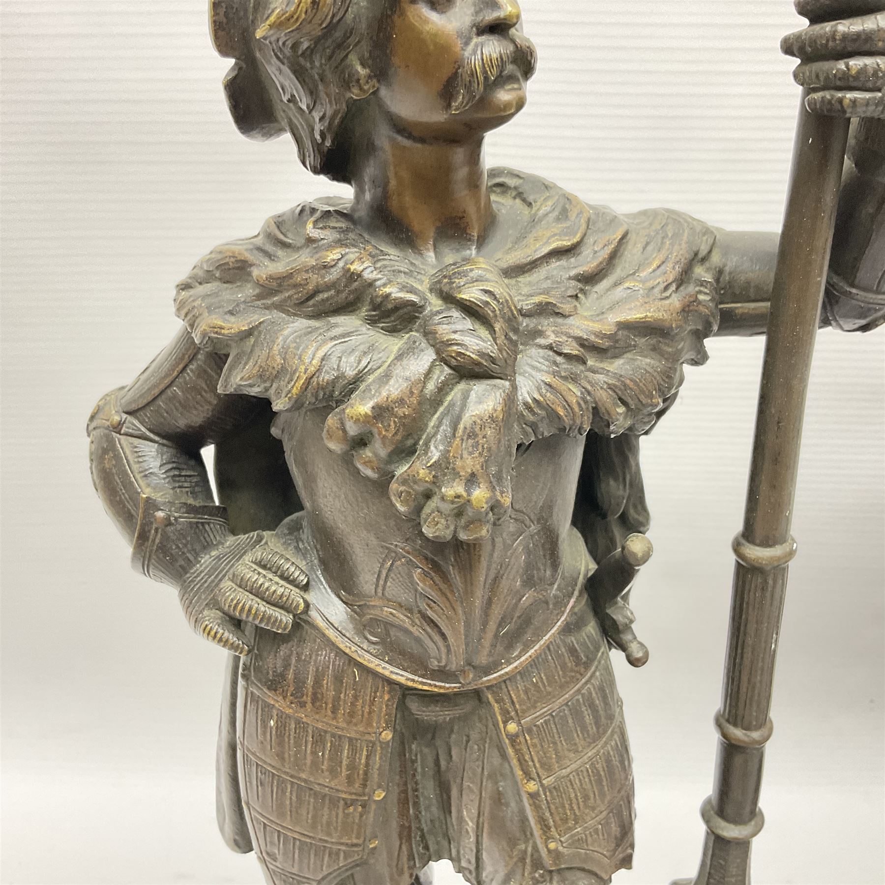 Pair of bronzed figure modelled as a hunter in traditional dress, each holding a pike, H48cm