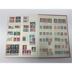 Mostly Great British stamps, including King Edward VII two shillings and sixpence, five shillings and ten shillings, King George V seahorses, King George VI high values, Queen Elizabeth II pre and post decimal etc, housed in a pink stockbook 