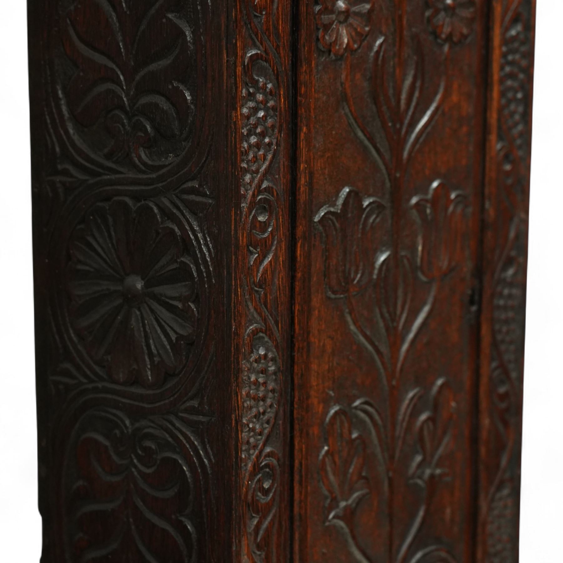 Man Beckett (I) of Stockton on Tees (Co Durham) - 8-day early 18th  century longcase clock in a  profusely carved oak case, with a caddy top, turned finials and attached barley twist pilasters to the break arch hood door, long trunk with carving and a conforming long rectangular door carved with a Celtic depiction of the tree of life, corresponding plinth with a carved and decorative base, break arch brass dial with a rounded brass surround, cast spandrels and silvered boss with the makers name to the arch, matted dial centre with seconds dial, ringed winding apertures, square date aperture and fettled steel hands, silvered chapter with Roman numerals, five minute Arabic's, half hour markers, minute and inner quarter hour tracks, dial pinned to a five pillar movement with inside countwheel striking and a recoil anchor escapement, striking the hours on a bell. With weights and pendulum.
Man Beckett (I), (first name is a biblical name short for Manasseh), was the first member of the Beckett family of prodigious clockmakers working in the North-East of England from 1720 until 1884.