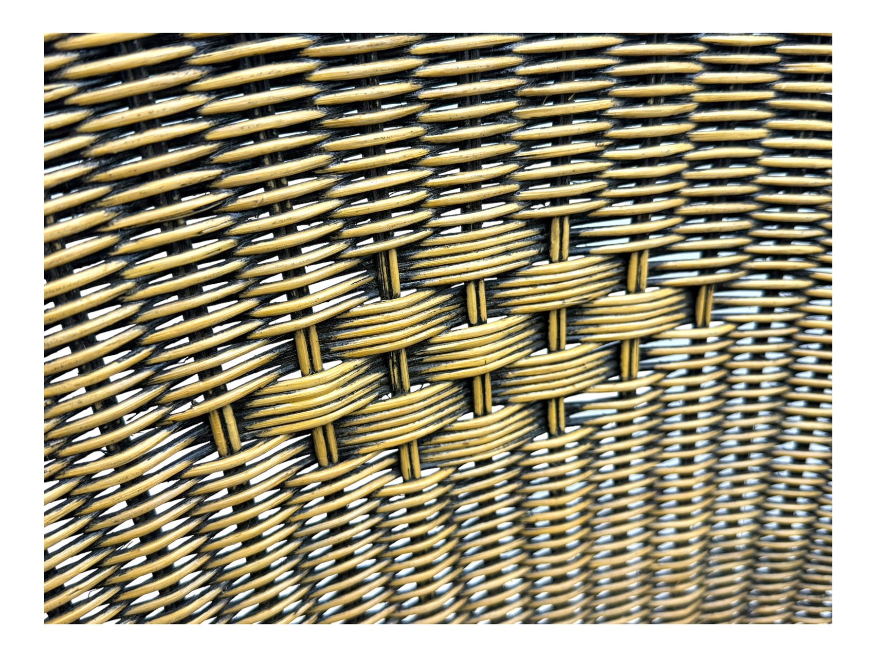 Late 20th century three-piece garden suite, wicker construction and wrought iron frame, decorated with cast metal leaf motifs, cream seat cushions and round back cushions