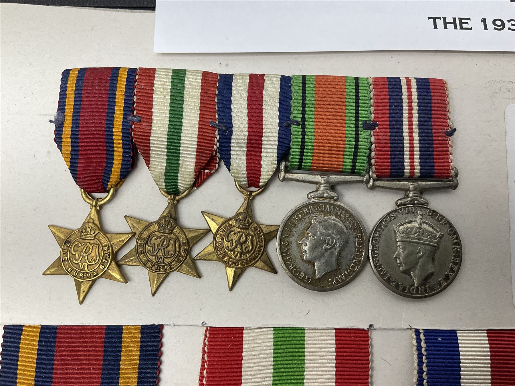 Representative display of WWII Campaign Stars and Medals comprising Burma Star, Italy Star, France & Germany Star, Defence Medal and War Medal 1939-1945; together with the corresponding group of miniatures; all with ribbons