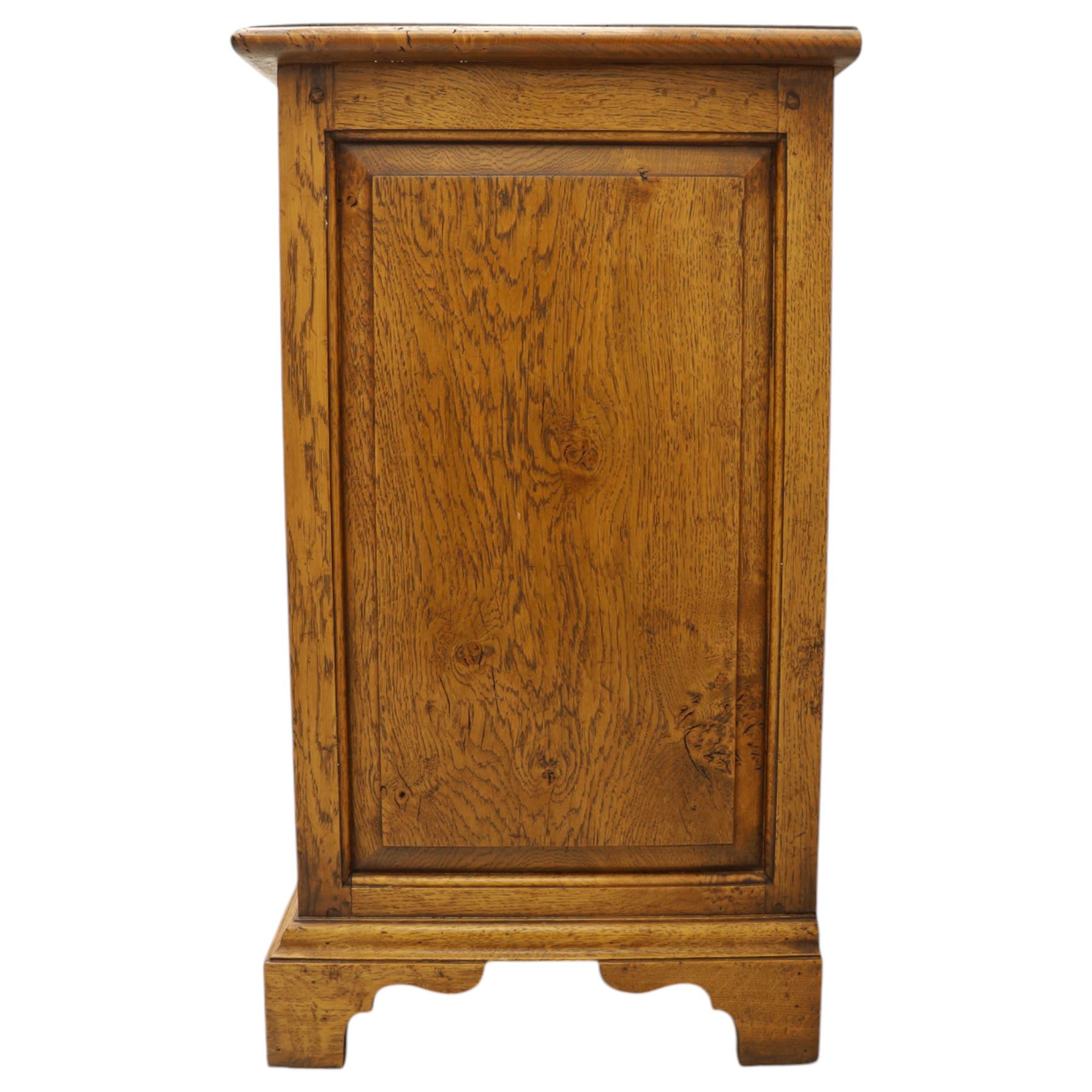 Small 20th century burr oak chest, the figured top over three graduated drawers with moulded fronts and pierced brass handles, on shaped feet