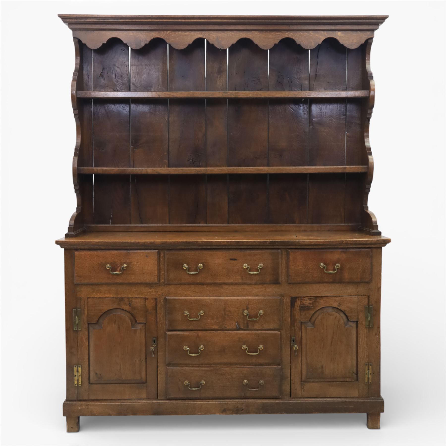 Georgian design oak dresser, the raised plate rack with shaped sides and two open shelves, upon a dresser base fitted with six drawers and two cupboard doors, and short block feet 