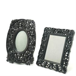 Chinese carved ebonised hardwood mirror, of oval form decorated with dragons and prunus bl...