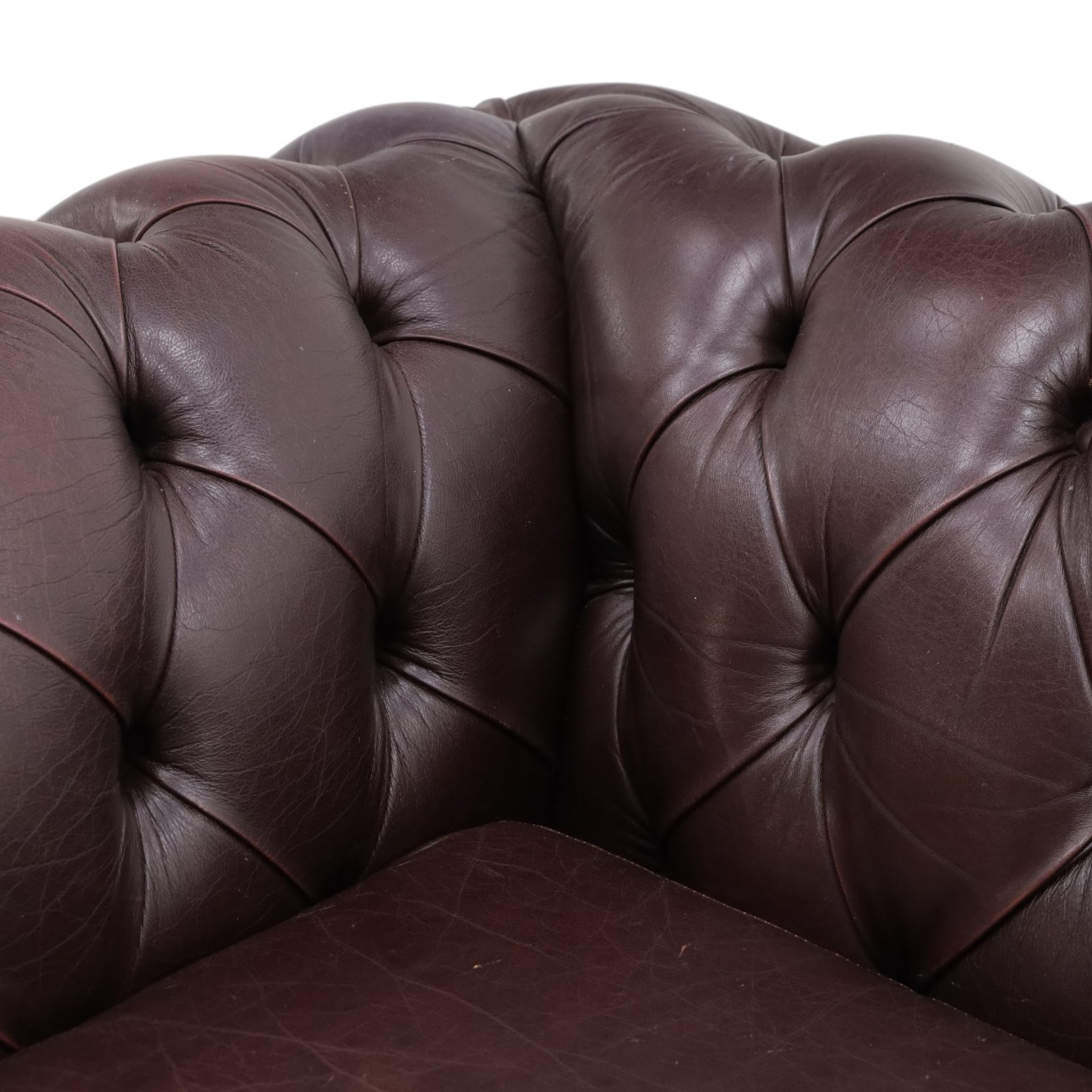 Thomas Lloyd - traditional shape Chesterfield two seater settee with rolled back and arms, upholstered in buttoned deep oxblood leather with loose seat cushions, raised on turned feet