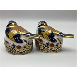 Two Royal Crown Derby Goldfinch Nesting paperweights with silver stoppers, together with two Royal Crown Derby imari pin dishes, largest dish D13cm