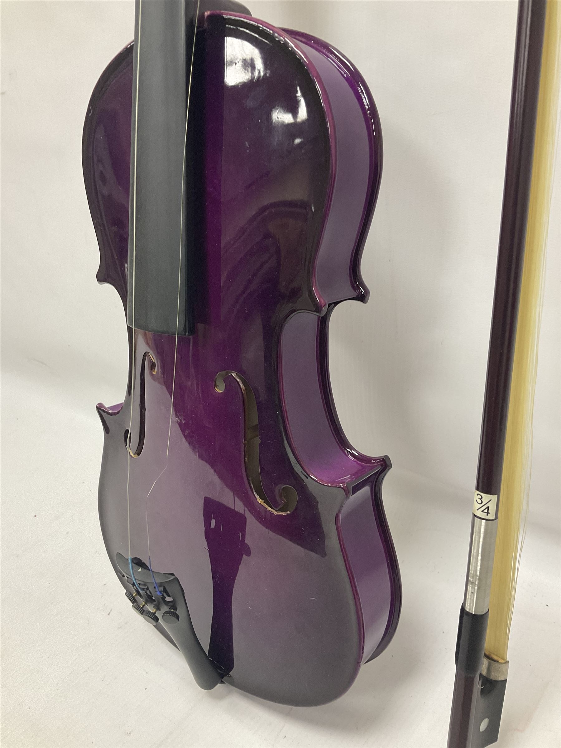Intermusic 3/4 violin with a violet coloured solid wood body, ebonised fingerboard and fittings, bow and hard case, length 54cm
