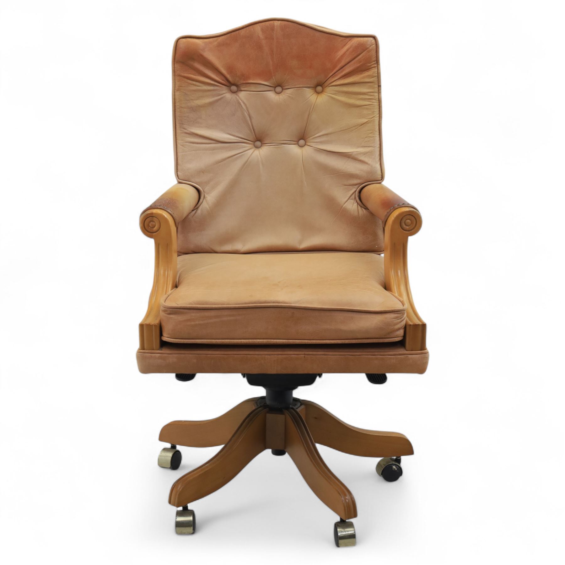 Late 20th century swivel executive desk chair, upholstered in tan leather with brass studded trim, raised on five point base raised on castors 