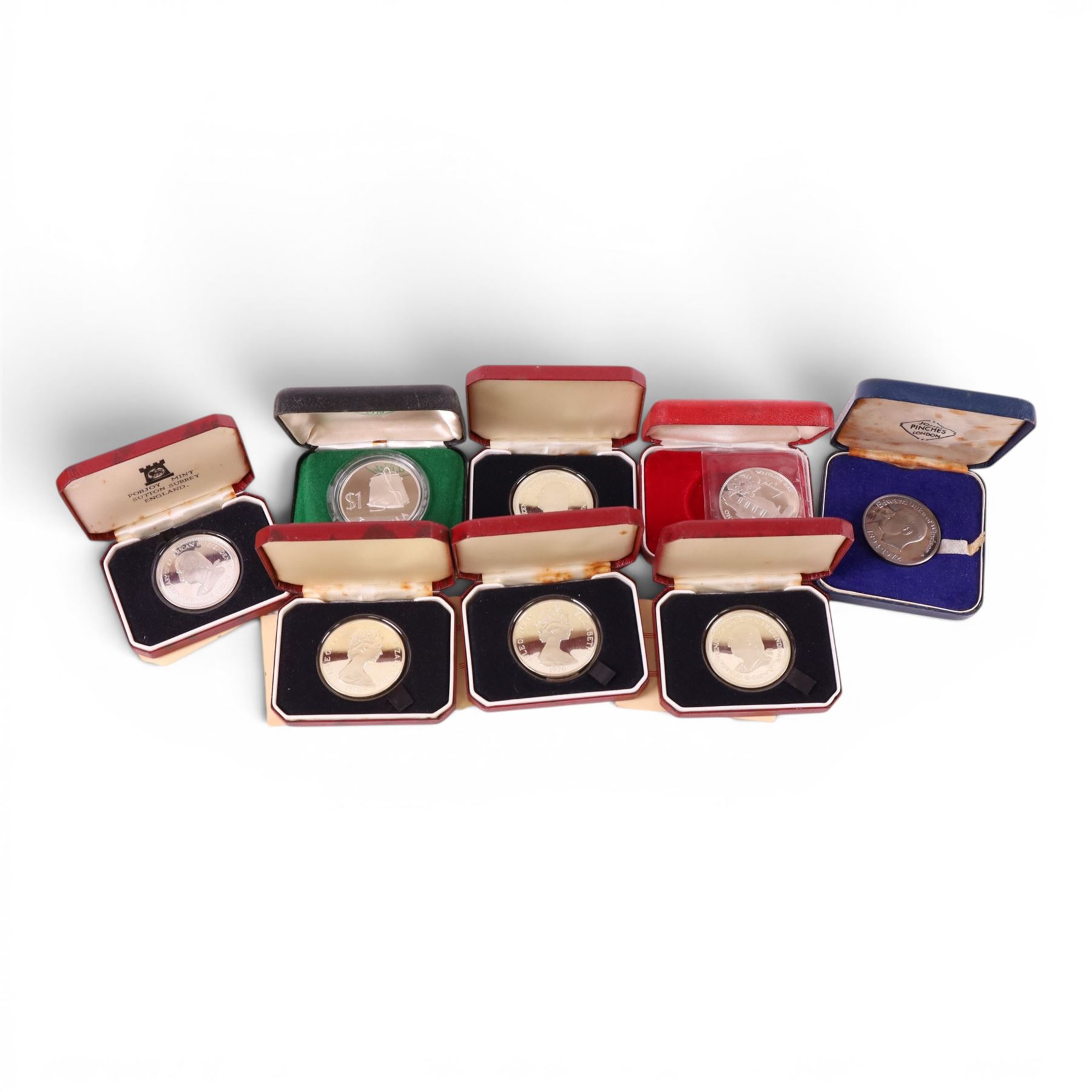 Seven silver proof coins, comprising five Queen Elizabeth II Isle of Man 1976 'Bicentenary of American Independence' crowns, Tokelau 1979 dollar, and New Zealand 1977 dollar, and a John Pinches 'Edward Duke of Windsor' silver medallion, all cased