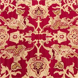 Large Persian Savonnerie-inspired style flatweave kilim, crimson field with central stylized palmette medallion with bold scrolling vinery and angular floral motifs between multiple guard stripes, rendered in tones of soft cream, pale sage, and muted terracotta, with fringe ends 