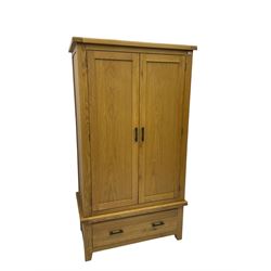 Light oak double wardrobe, enclosed by two panelled doors, fitted with single drawer