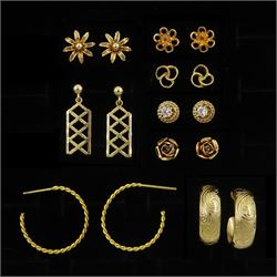 Eight pairs of 9ct gold earrings including flower head and hoop, all hallmarked