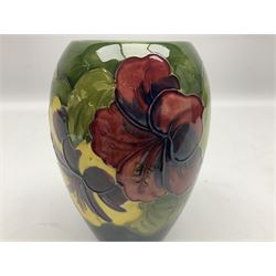 Moorcroft Hibiscus pattern vase of ovoid form, decorated with pink, yellow and purple flowers on merging blue and green vase, with impressed and painted marks beneath, H18cm