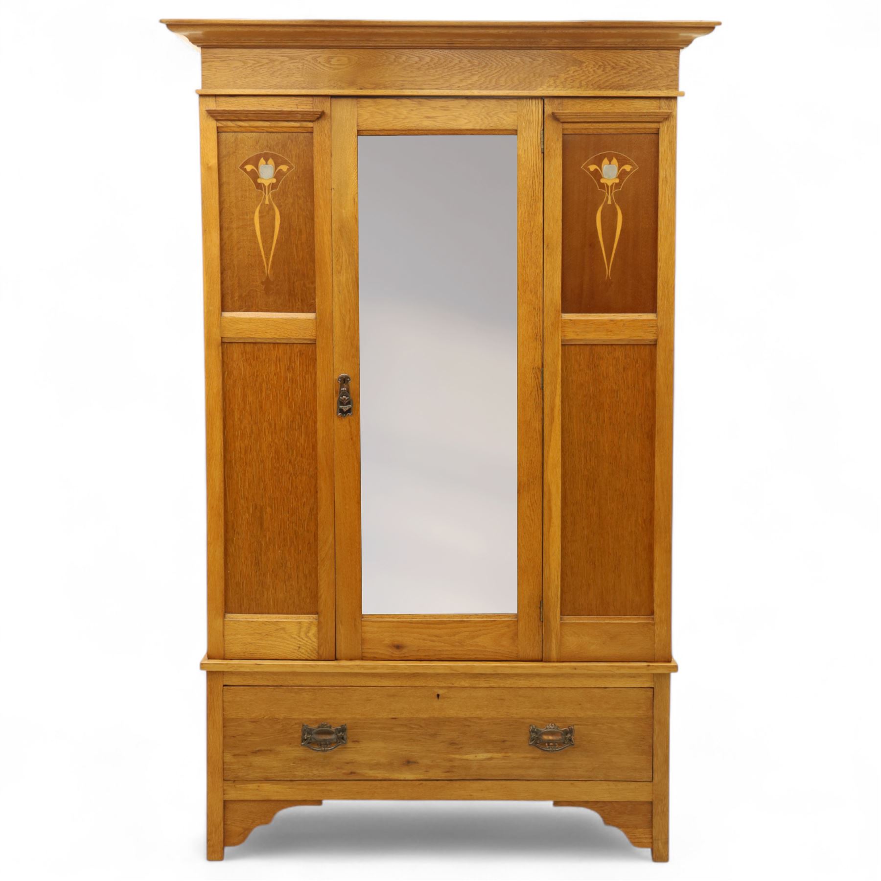 Art Nouveau oak wardrobe, central mirrored door flanked by panels inlaid with stylised tulip motifs, fitted with hanging rail and hooks, single drawer to base with brass handles