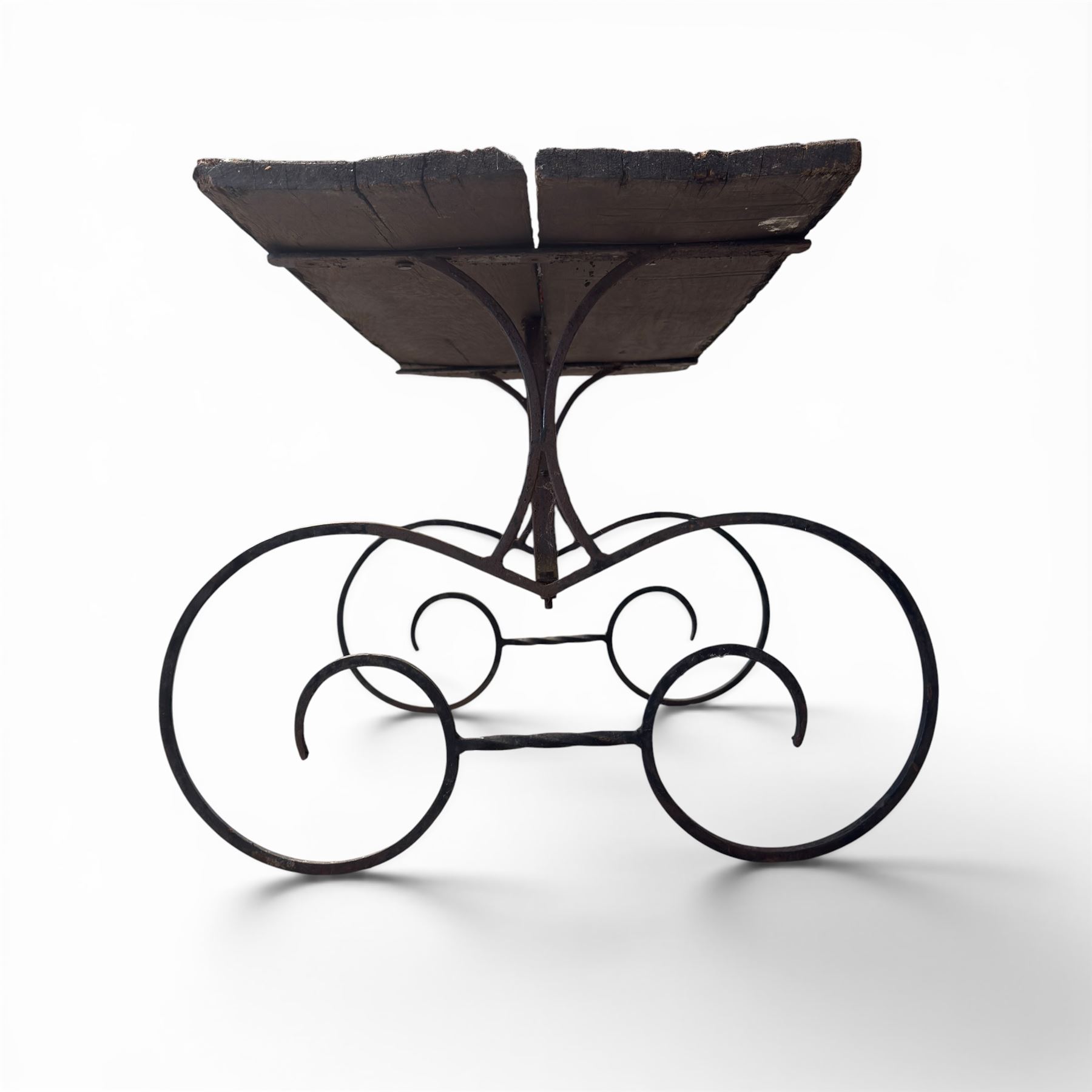 Cast iron garden table, with rectangular weathered slatted wooden top, raised on iron strapwork supports of scrolling form, in black painted antique finish 
