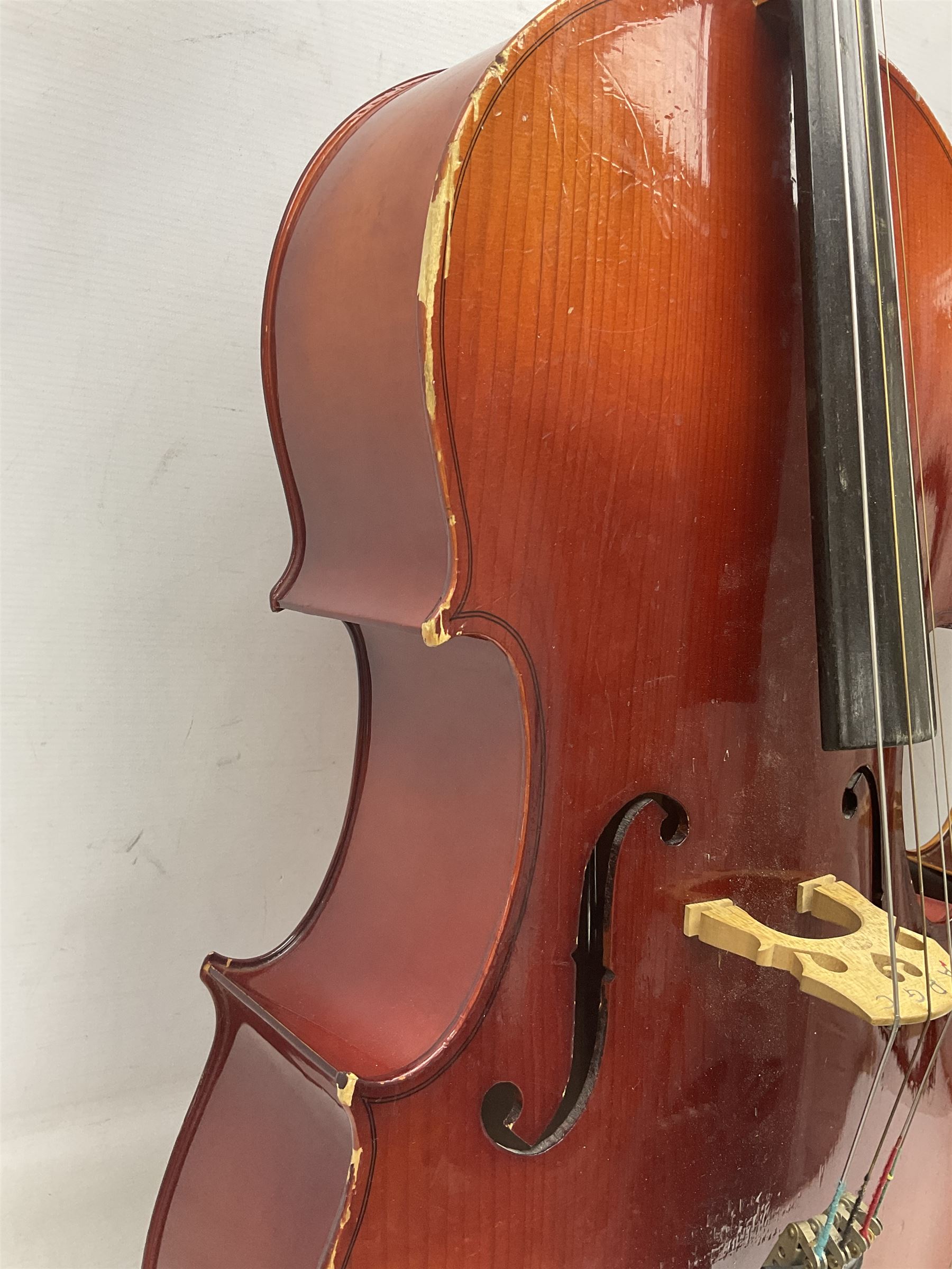 Two student half-size cellos - Boosey & Hawkes Artia with 65cm one-piece back and spruce top; bears maker's label; L104cm overall; and Romanian with 65.5cm two-piece maple back and ribs and spruce top; bears label; L108.5cm overall; each in soft carrying case with two bows (2)