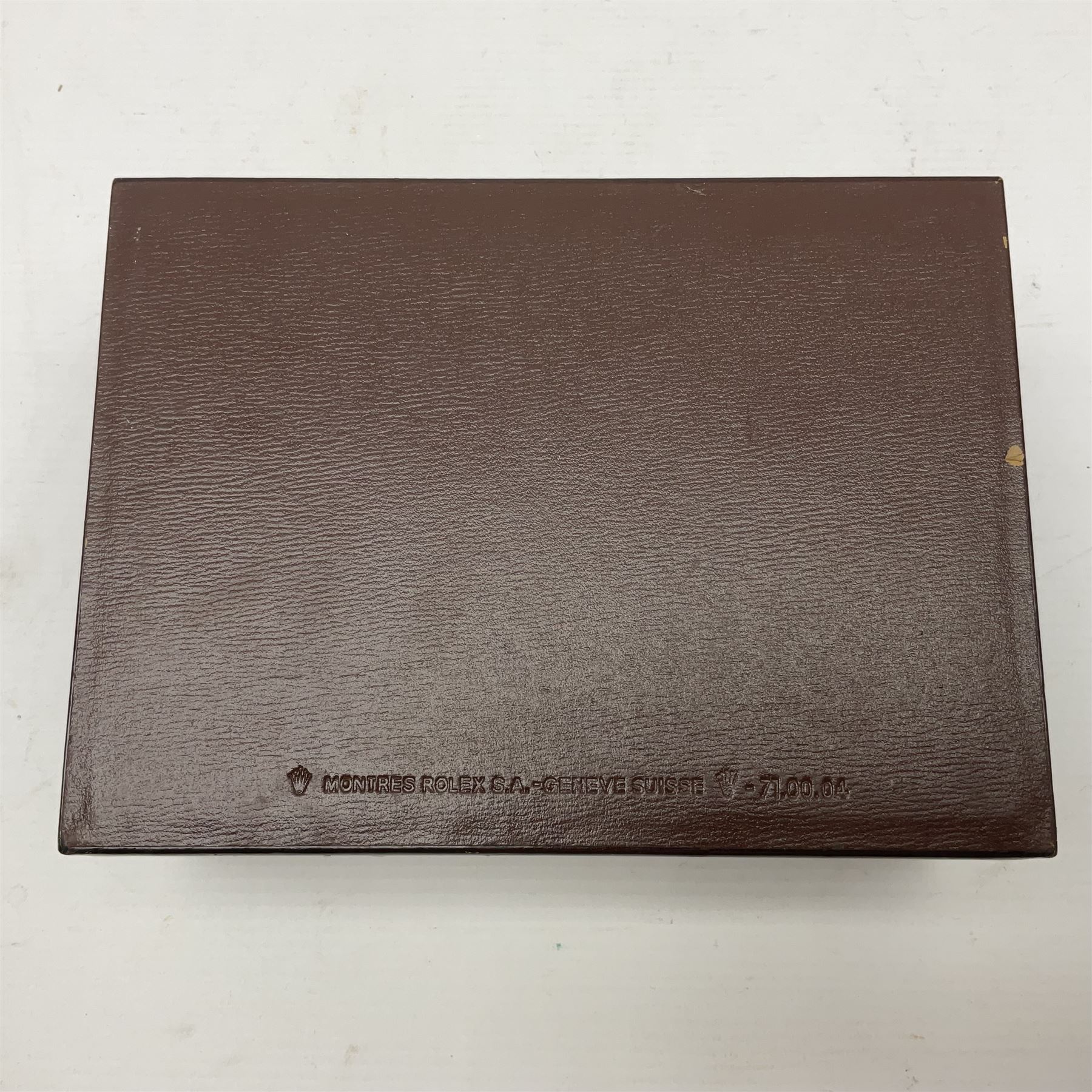 Rolex brown leather box, with decorative buckle to cover, opening to reveal wooden veneer interior, the inside lid stamped in gilded lettering 'Creation Genève Rolex', stamped beneath 'Montes Rolex S.A. Geneve Swiss 71.00.04, H8cm