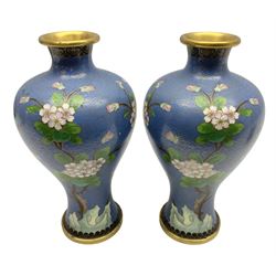 Pair of Chinese cloisonné vases decorated with birds and blossoming branches upon blue ground, H23cm
