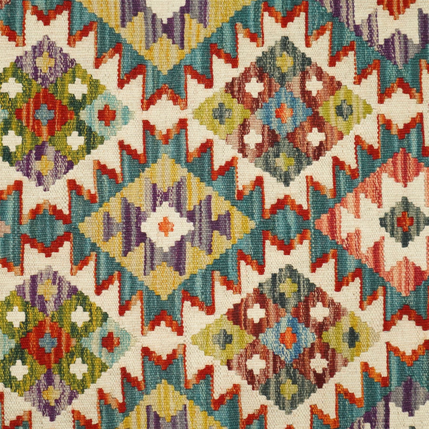 Chobi kilim runner, flatwoven with repeating hooked diamond motifs in shades of red, green, blue, yellow and cream, framed by geometric guard borders
