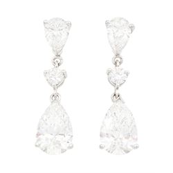 Pair of platinum diamond pendant earrings, each stud set with two pear cut diamonds, of 1....