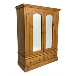 Pine double wardrobe, enclosed by two mirror glazed doors, two drawers to base