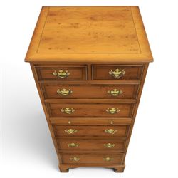 Georgian design yew wood pedestal chest, fitted with seven drawers and slide, brass drop handles