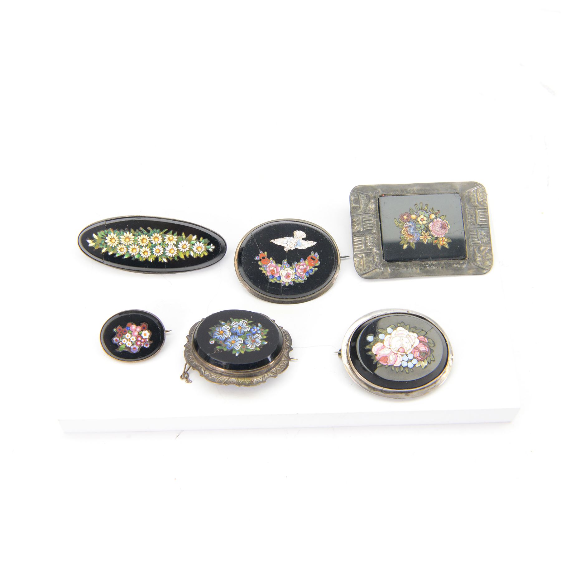 19th century micro mosaic brooch of oval form decorated with daisies to the centre, together with five other micro mosaic brooches 