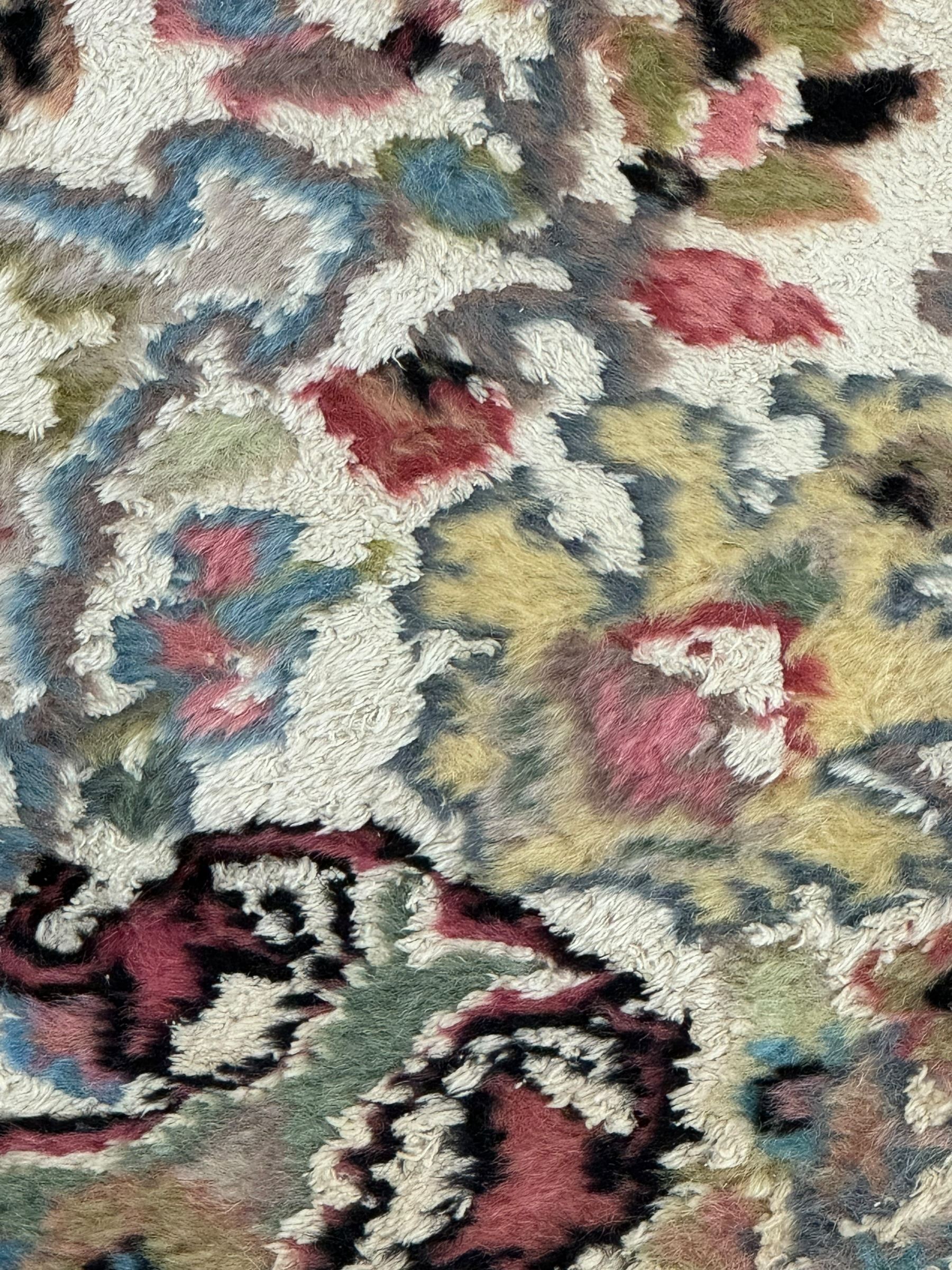 Persian design ivory ground rug, overall floral design with shaped central medallion, the main border decorated with trailing flower head pattern, within guard stipes 