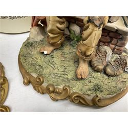 Four Capodimonte figure groups, to include tramp figures, shoemaker figure etc