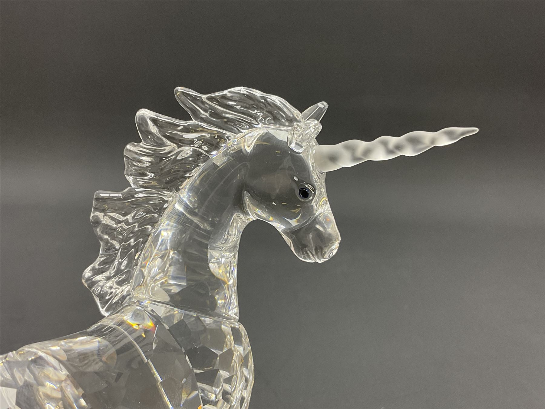 Swarovski Crystal animals, comprising white peacock, the tail with cascading blue flowers, perched eagle with yellow beak, ibex with frosted crystal horns and unicorn with frosted crystal horn, tallest H13cm