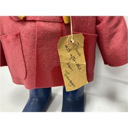 Pair of Paddington Bear teddies with amber eyes, the first example having a brown felt hat, red coat and blue PB boots with original label; the second having a grey felt hat, blue coat and blue Dunlop boots, tallest H51cm 
