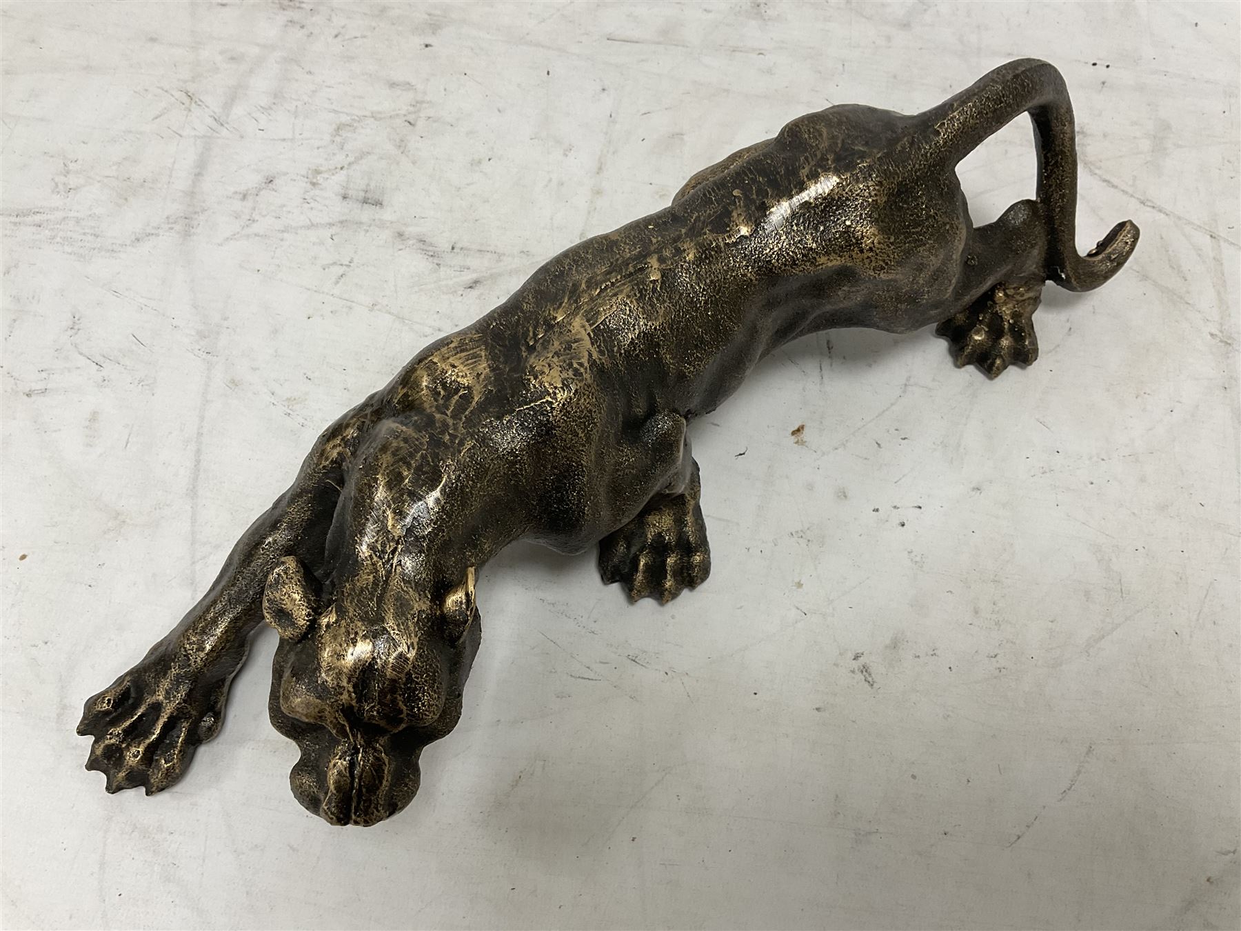 Cast metal figure modelled as a cougar in crouching pose, L40cm