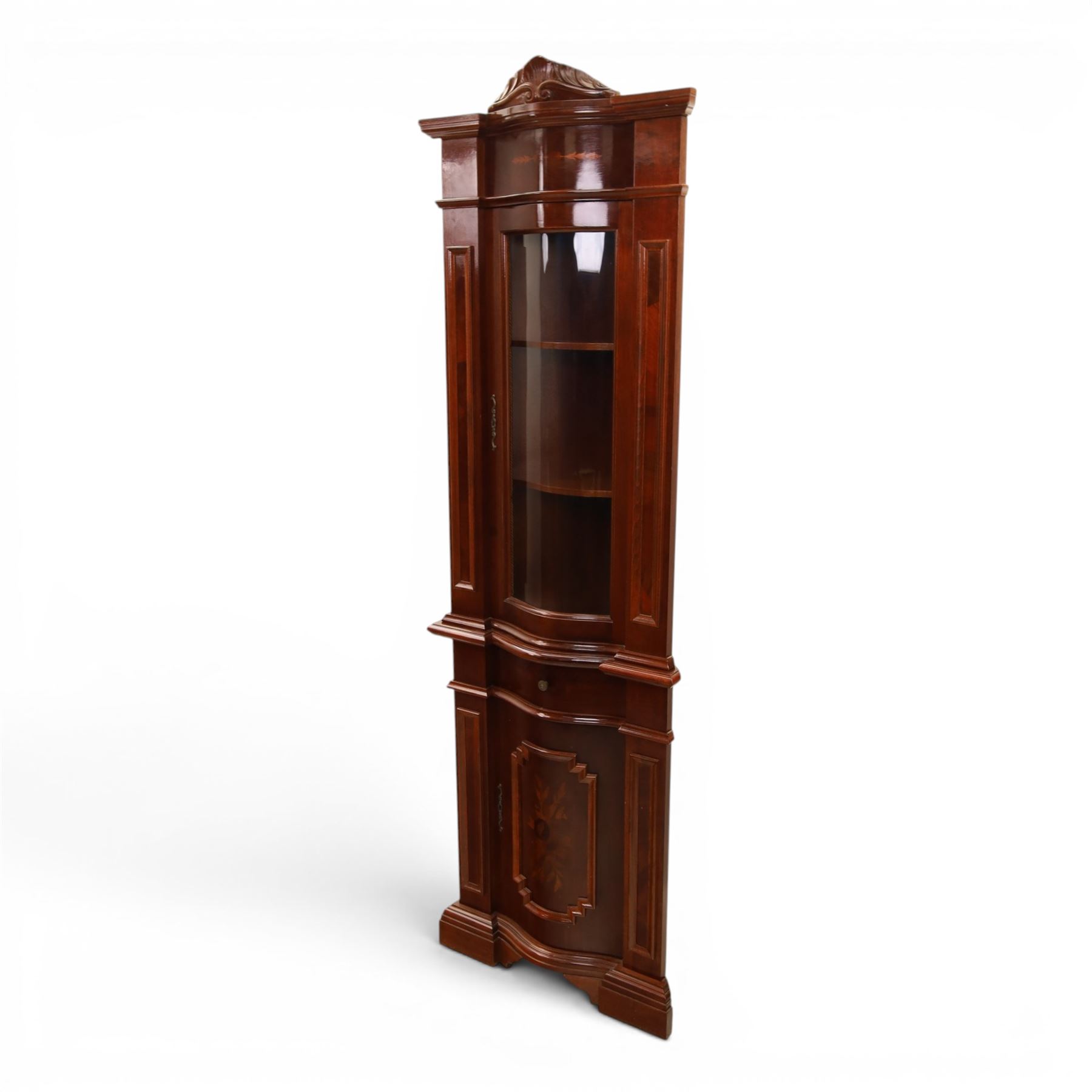 Victorian design mahogany corner cabinet, shaped carved cresting above bowed glazed upper door, with panelled side uprights, lower drawer over cupboard door decorated with floral marquetry, on plinth base