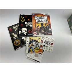 Nintendo Wii console, four controllers with cases and four nunchucks, Wii sensor bar, balance board and dance mat. Guitar hero wireless guitar for Wii and Redoctane wired guitar. Nintendo DS lite handheld gaming console, console and game cases and Guitar Hero Redoctane Guitar Grip. Selection of Nintendo Wii and Nintendo DS lite games to include Super Mario Galaxy, Guitar Hero, Wii Fit, Legend of Zelda games etc. Archos AV400 Series pocket video recorder with accessories, cradle and remote, in three boxes